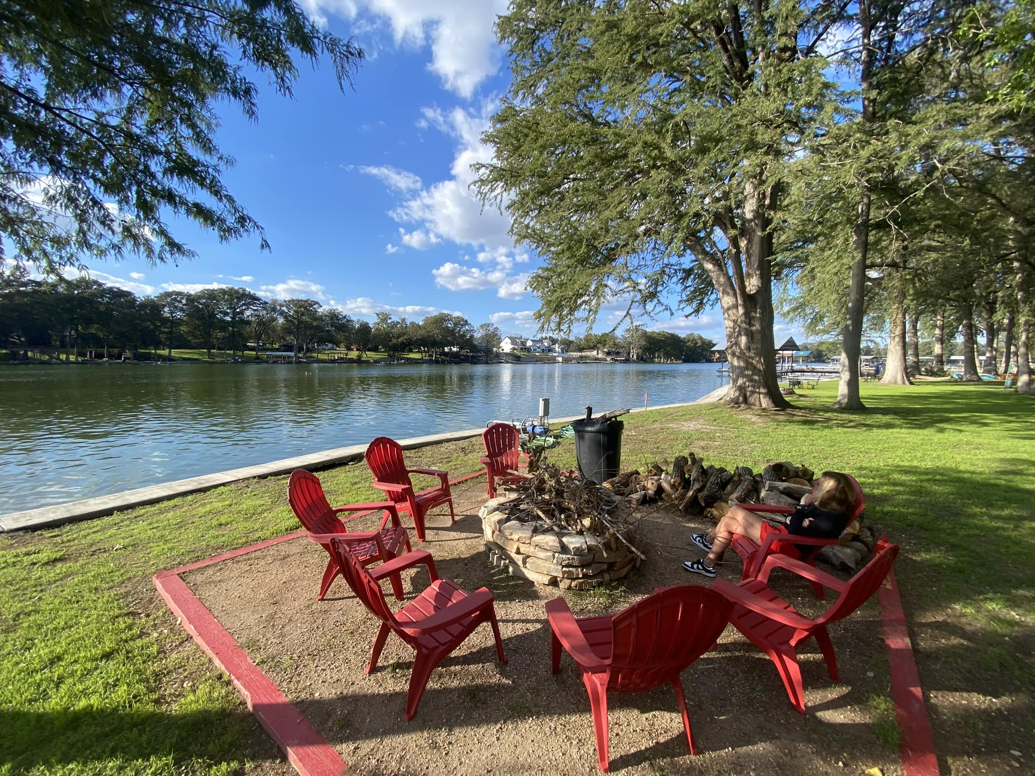 Red chairs by the water at Camp Willow
